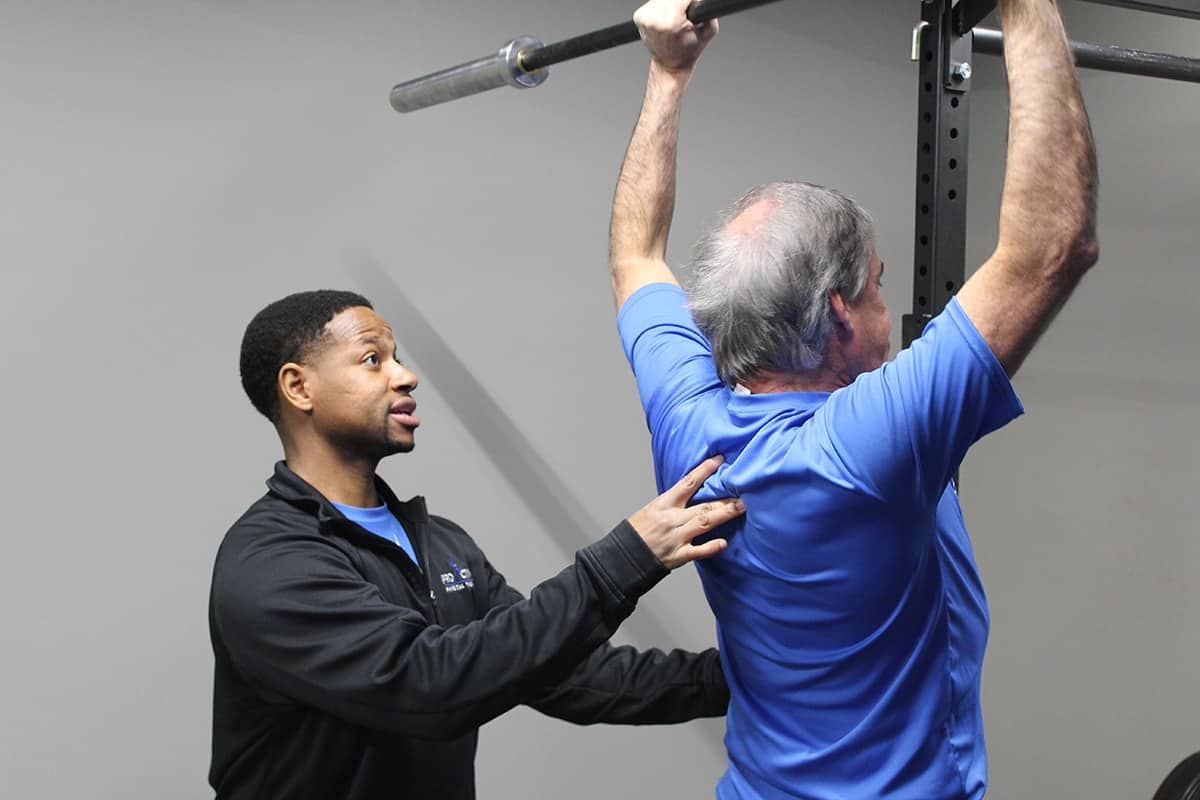 Personal trainer working one-on-one with a client over 45 at ProActive Physical Therapy in Louisville, KY.